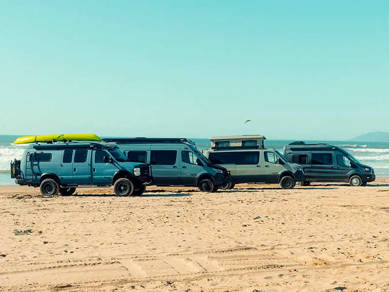 four-field-vans-parked-together