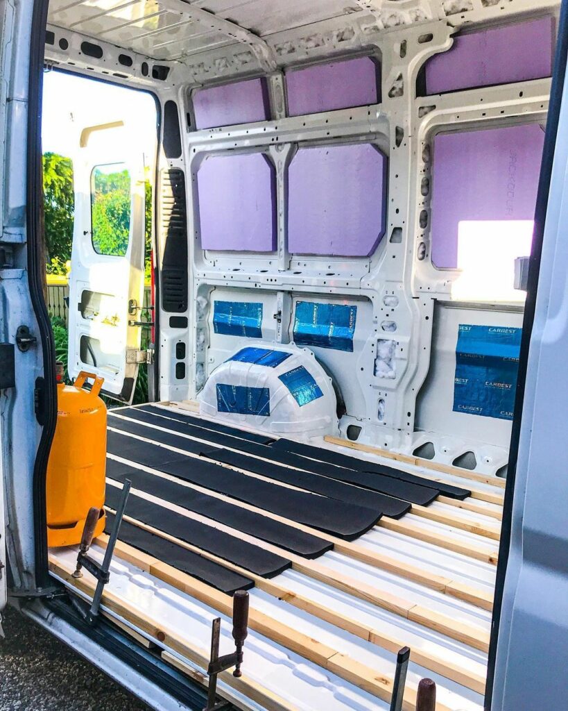 van build through slider door view with insulation and floor installed