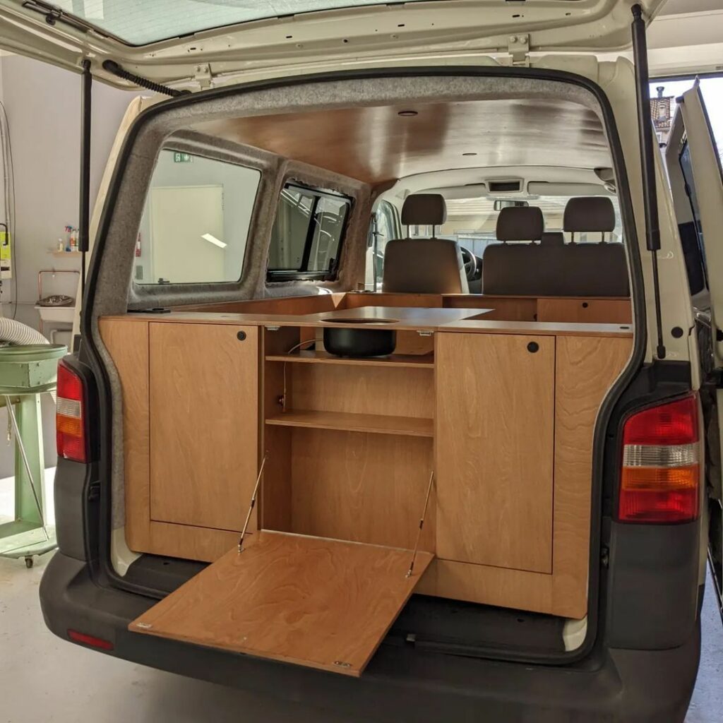 entire cabinet system with drawers installed into rear campervan conversion