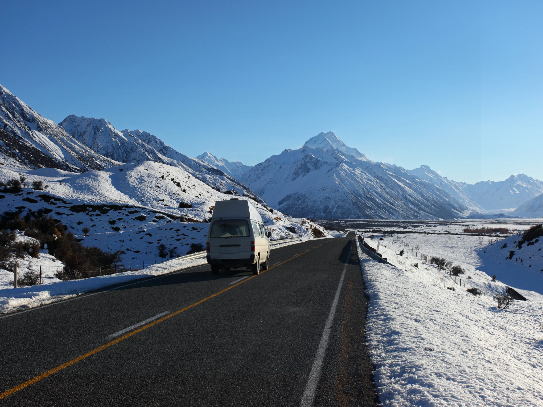 pop top camper on the road in snow