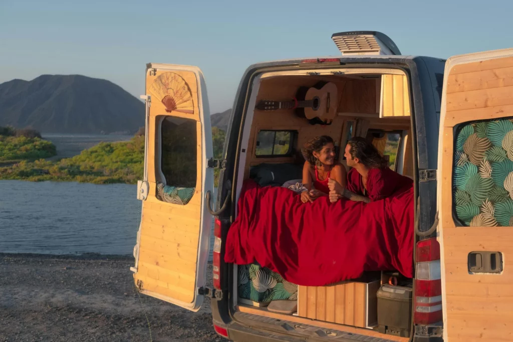 couple hangs in campervan with rear doors open