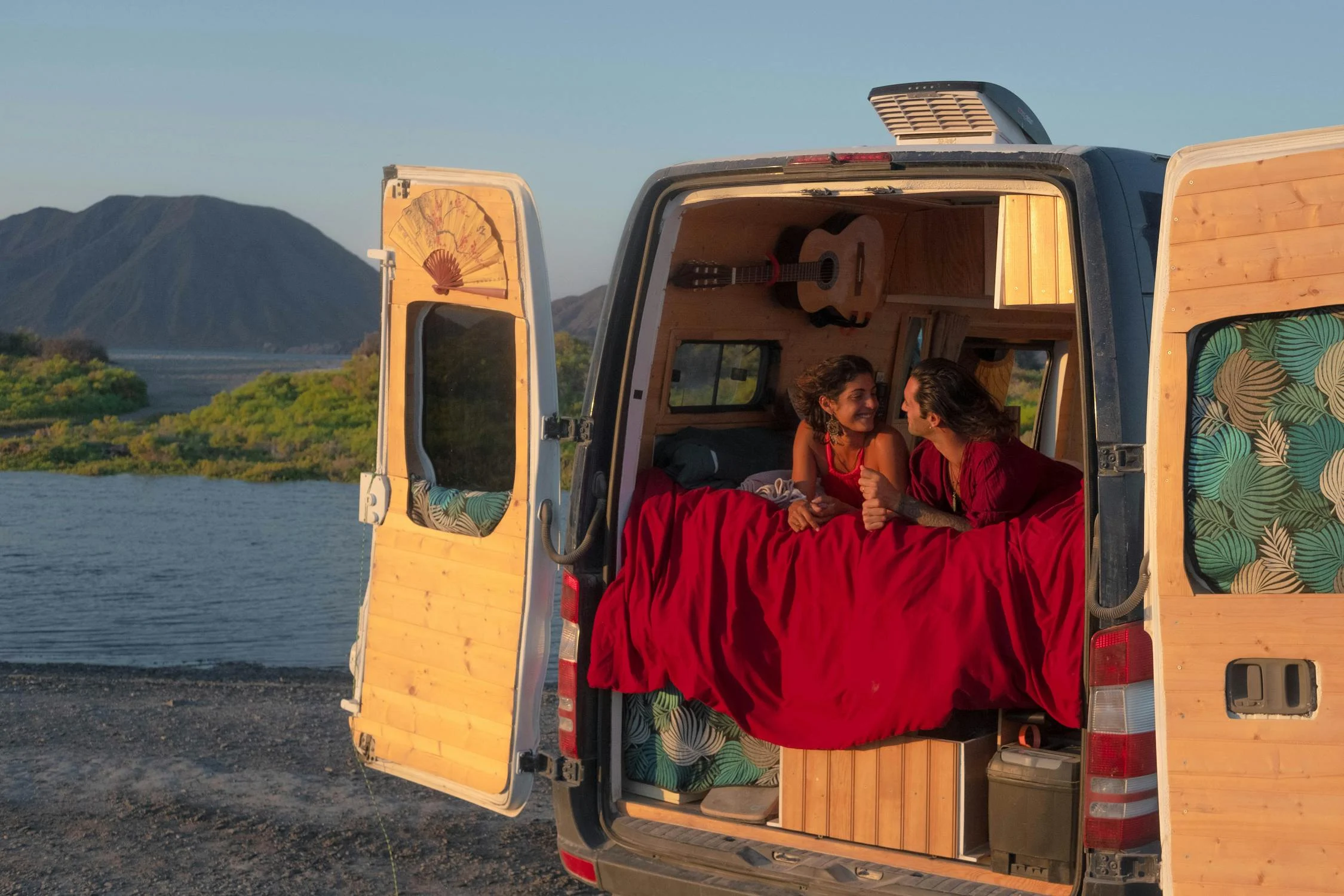 couple hangs in campervan with rear doors open