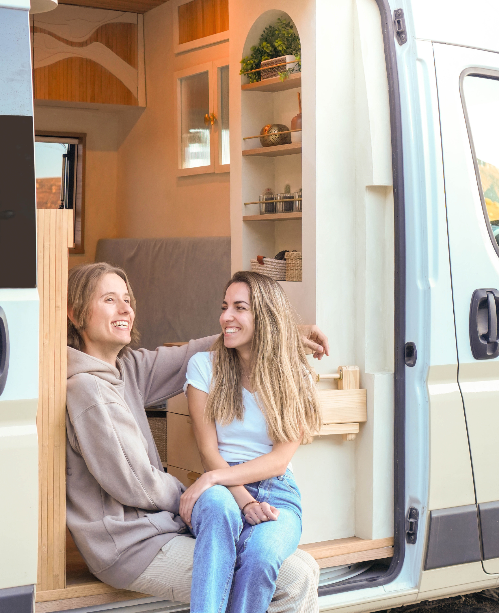 People sitting in the doorway of a camper van