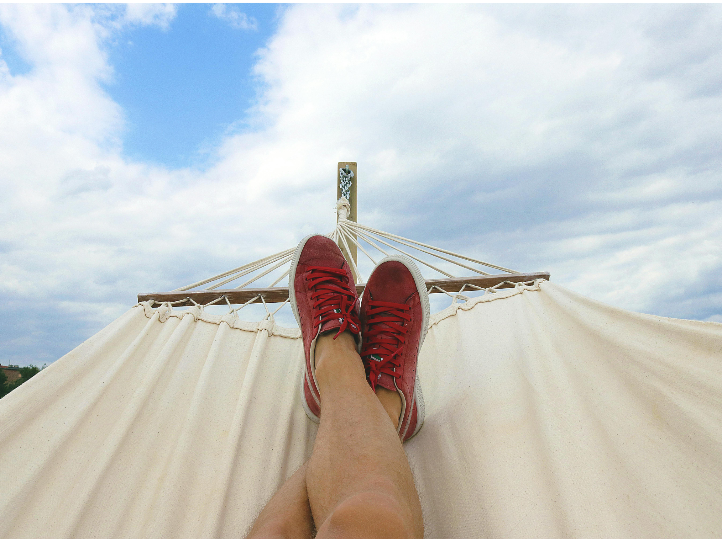 person relaxing in hammock on their van life break