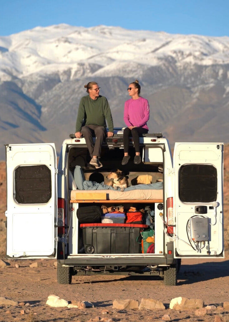 Couple sitting on roof of ram promaster van conversion