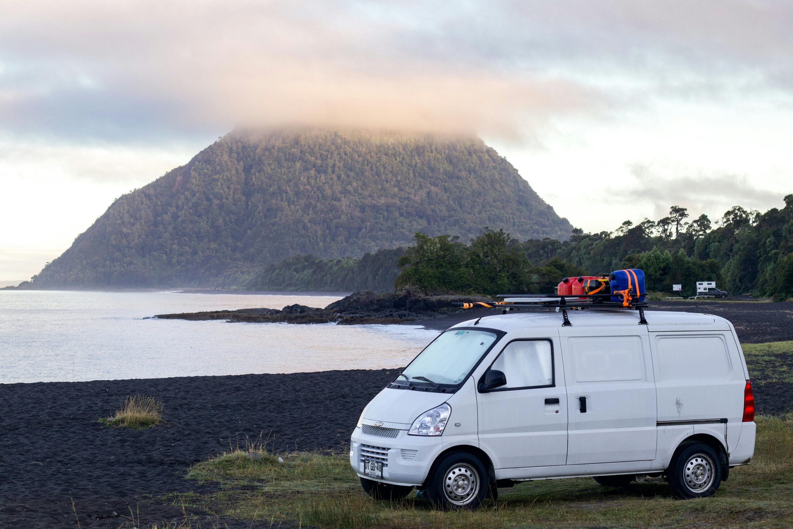 Camper van on a road trip parked on beach