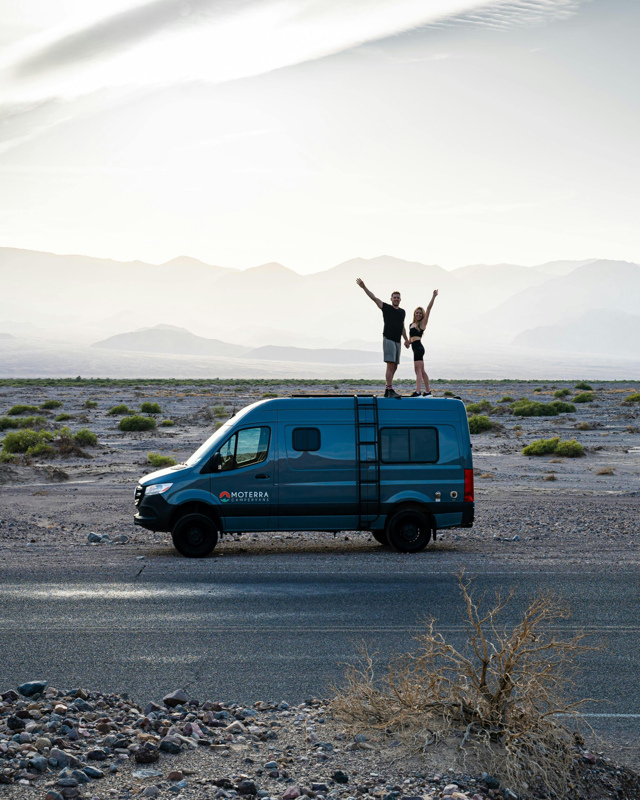 People standing on Moterra camper van rental next to road