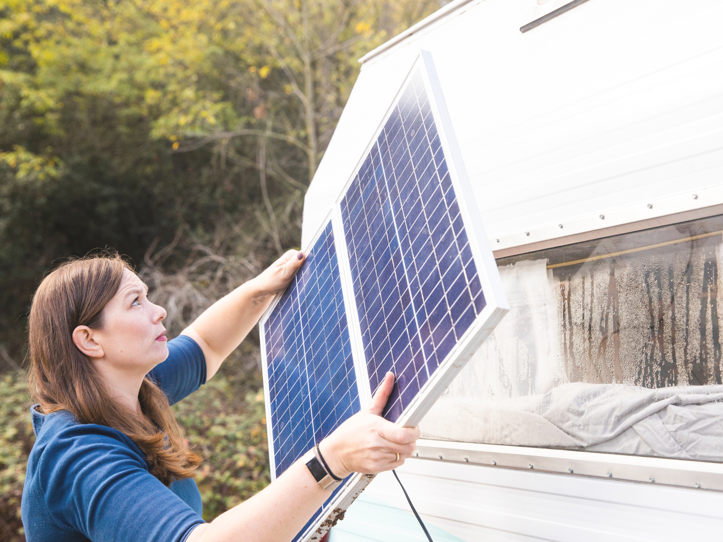 woman installing camper van solar panels