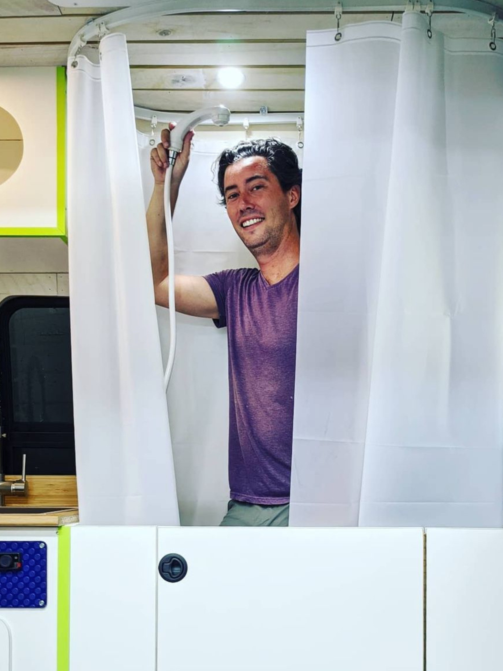 Person using a camper van bathroom shower