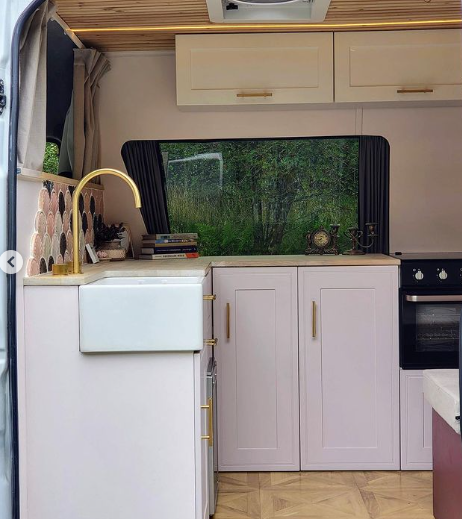 view of camper van kitchen through sliding door