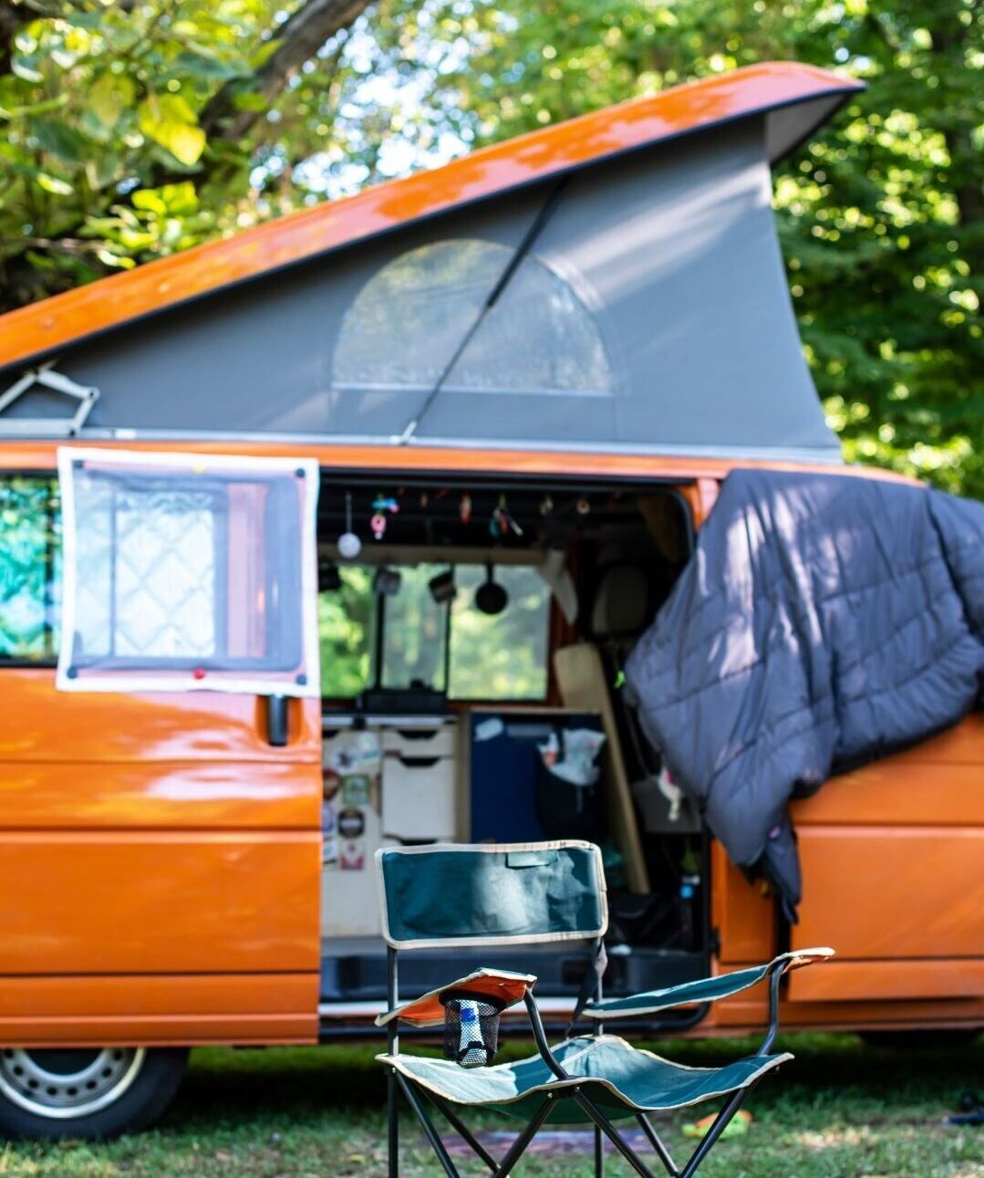 Camp chair in front of micro camper van