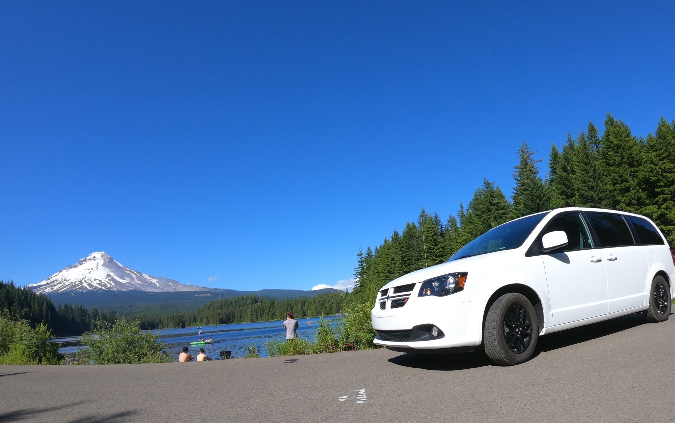 Avanti campervan on a road trip in front of a lake and mountain