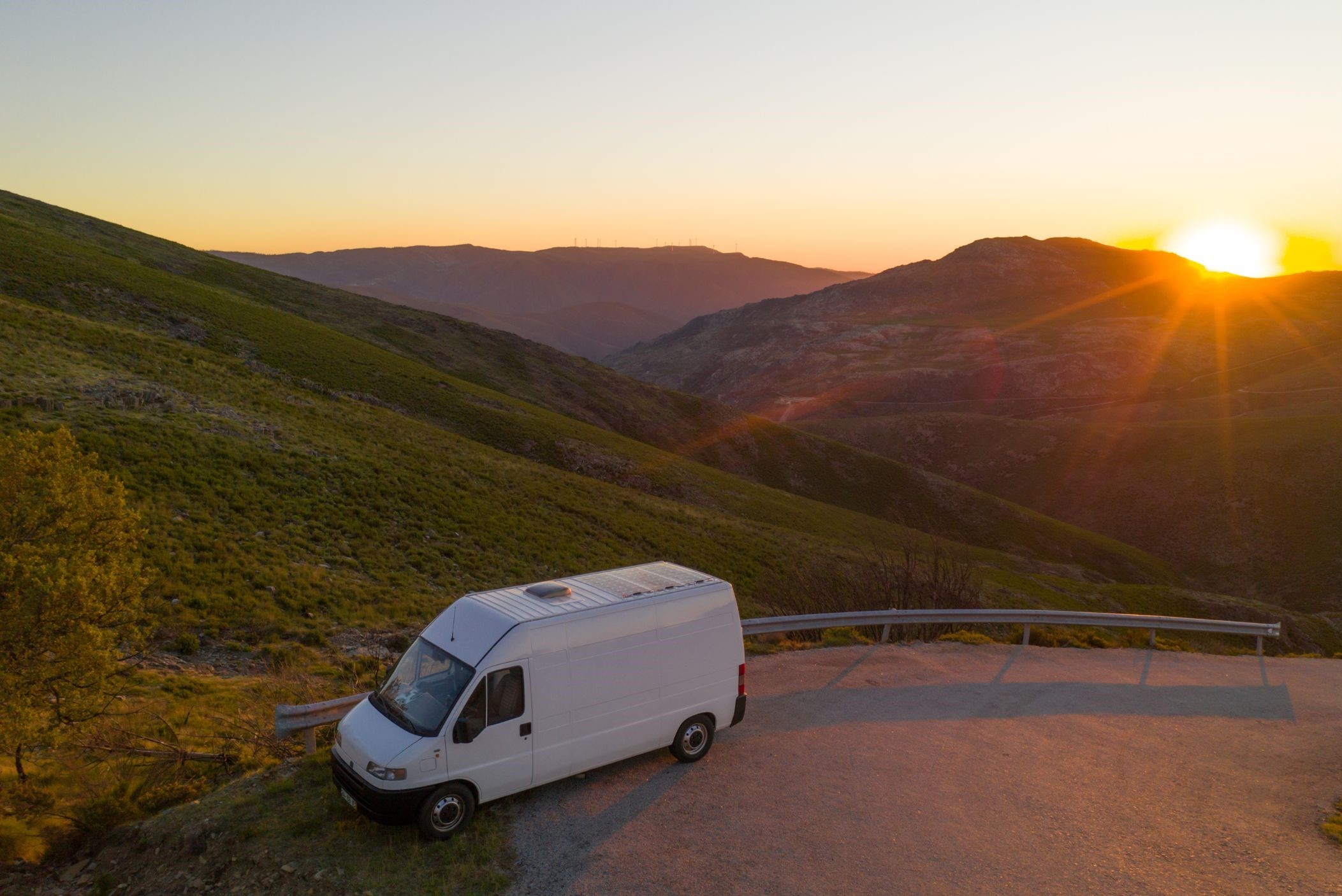 Van camping on pullout among hills