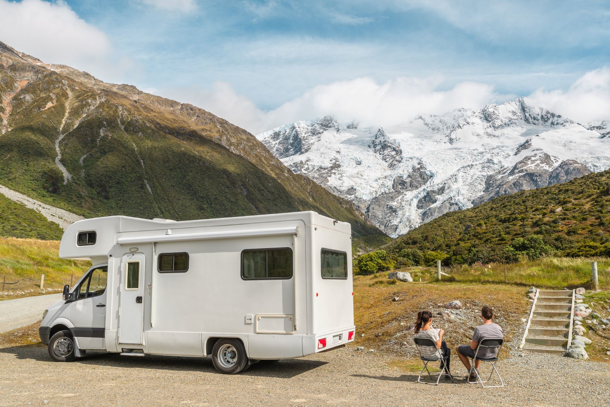 People camping in an RV near mountains