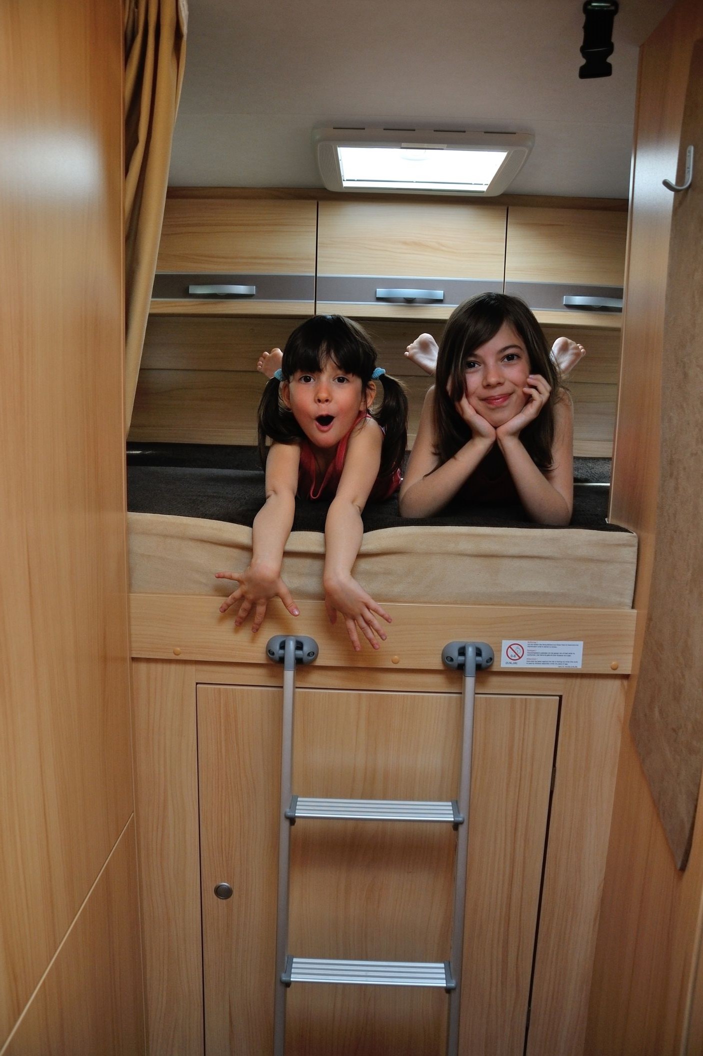 Kids in bed in family camper van